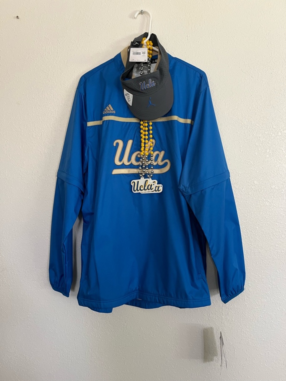 NWT. 1 UCLA Adidas windbreaker Lg. 1 Visor and  2 Mardi Gras beads.